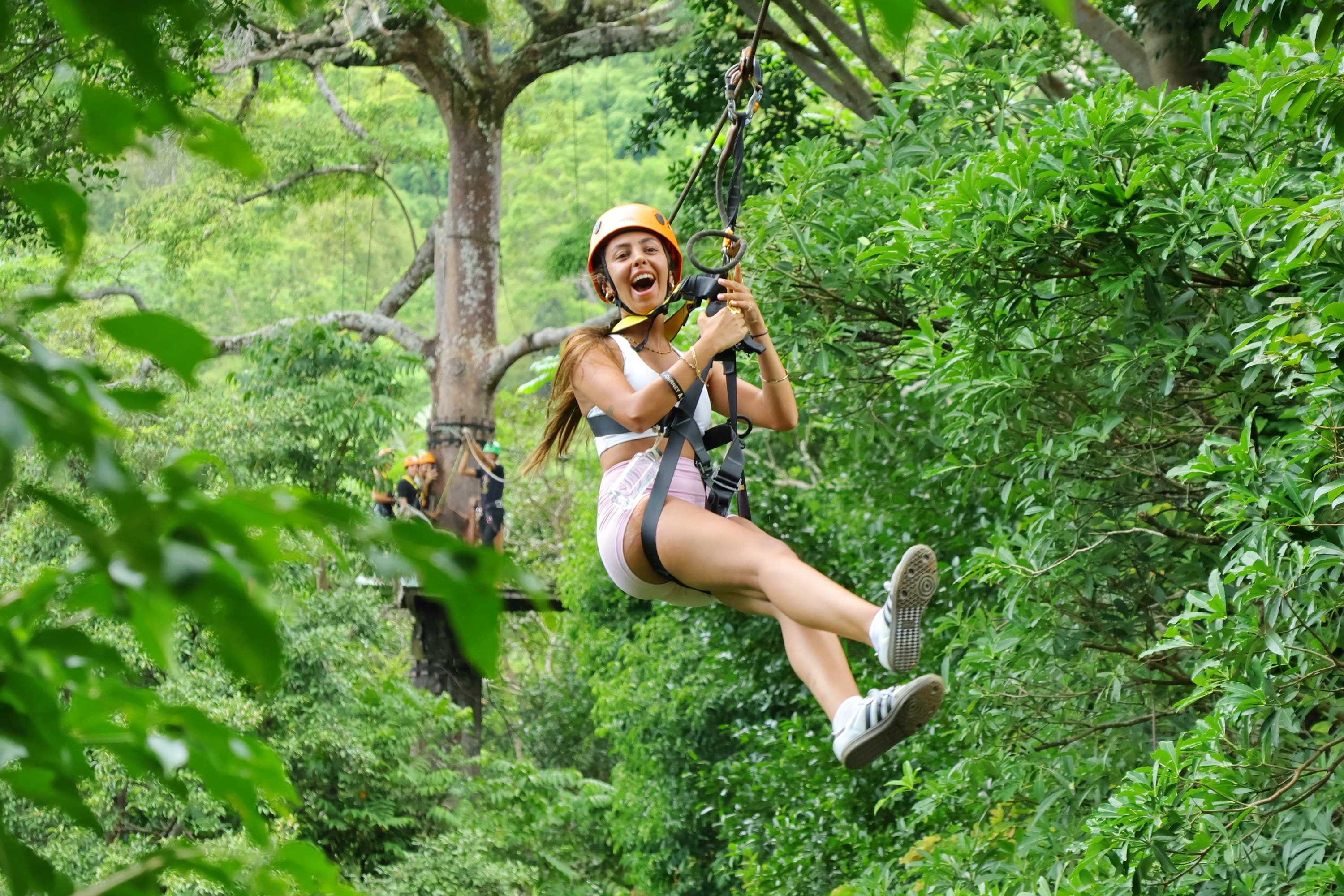 A guest using Flying Hanuman zipline safety equipment